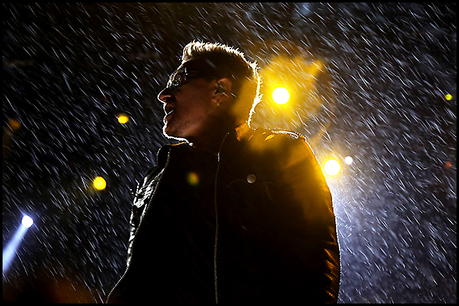 Bono (Lead Singer) from U2 perform in torrential rain at the 2011 Glastonbury Festival.