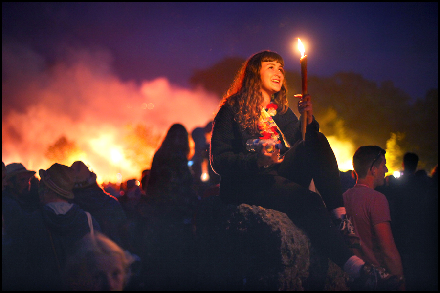 A young woman enjoys the chilled ambience at the Stone Circle on the first night of the Glastonbury Festival.