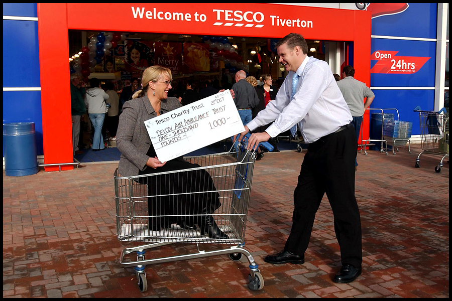 Richard Dodd (Store Manager) presents a chque for 1000 to Lyn Paver (CEO- Devon Air Ambulance) at the Tesco store in Tiverton, Devon. CLIENT: Tesco.